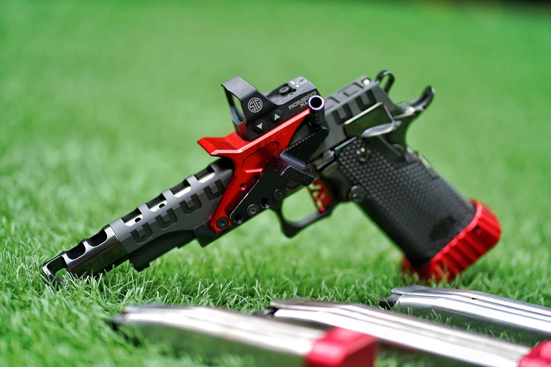 Lorco 2011 Open Pistol with a red and black finish, photographed on grass.